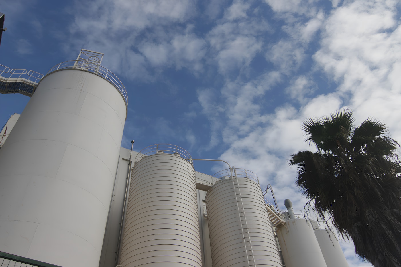 Industrial silos and manufacturing facility under a blue sky